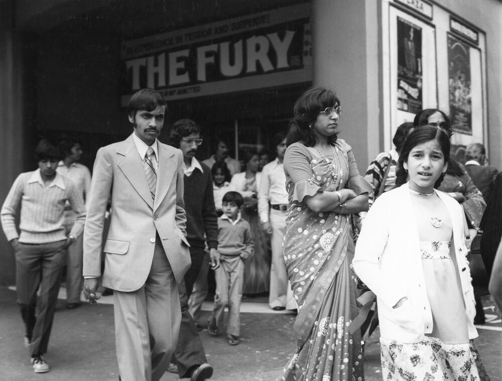 Members of the Indian community outside the Plaza Theatre
