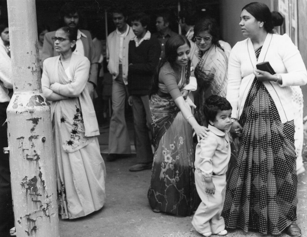 Members of the Indian community outside the Plaza Theatre
