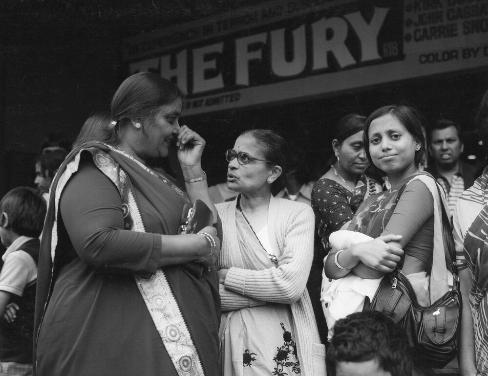 Members of the Indian community outside the Plaza Theatre