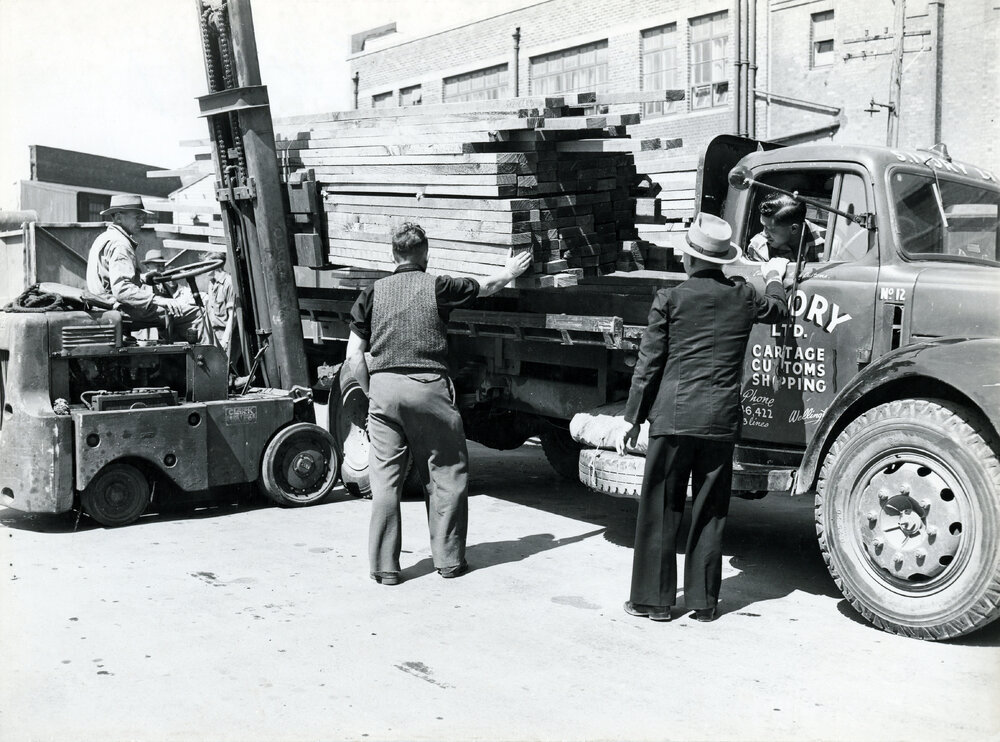 Unloading timber at the wharf