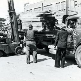 Unloading timber at the wharf